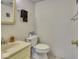 Simple bathroom featuring a toilet, sink with faucet, and a towel rack at 1612 Westbay Ct, Indianapolis, IN 46260
