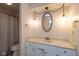 Bathroom with a white vanity, marble-style countertop, and vintage lighting at 1612 Westbay Ct, Indianapolis, IN 46260