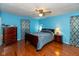 Serene bedroom with rich hardwood floors and an elegant ceiling fan, bathed in soft, natural light at 1612 Westbay Ct, Indianapolis, IN 46260