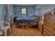 Comfortable blue bedroom with hardwood floors, natural light, and ample closet space at 1612 Westbay Ct, Indianapolis, IN 46260