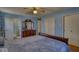 Comfortable bedroom with light blue walls, ceiling fan, and ensuite bathroom and large closets at 1612 Westbay Ct, Indianapolis, IN 46260