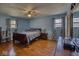 Spacious bedroom with hardwood floors, two windows, a ceiling fan, and classic decor at 1612 Westbay Ct, Indianapolis, IN 46260