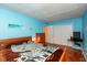 Bedroom with vibrant blue walls and wooden furniture, providing ample storage and a comfortable space at 1612 Westbay Ct, Indianapolis, IN 46260