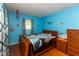 Cozy bedroom featuring bright blue walls and wooden furniture, creating a warm and inviting atmosphere at 1612 Westbay Ct, Indianapolis, IN 46260