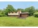 Backyard view of two-story home with brick accents, lush green lawn, and mature trees at 1612 Westbay Ct, Indianapolis, IN 46260