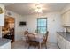 Eat-in kitchen features tile flooring, white cabinets, and a cozy breakfast area at 1612 Westbay Ct, Indianapolis, IN 46260