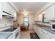 Bright kitchen with white cabinets, tiled floor, and breakfast nook area at 1612 Westbay Ct, Indianapolis, IN 46260