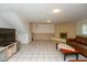 Spacious living room with fireplace, tile flooring, and comfortable leather seating at 1612 Westbay Ct, Indianapolis, IN 46260