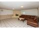 Inviting living room features a functional brick fireplace and a comfortable leather sectional sofa at 1612 Westbay Ct, Indianapolis, IN 46260