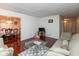 Elegant living room with hardwood floors, comfortable seating, and view into dining area at 1612 Westbay Ct, Indianapolis, IN 46260