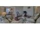 Spacious living room with hardwood floors, comfortable seating, and an open view into the dining area at 1612 Westbay Ct, Indianapolis, IN 46260