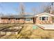 Spacious backyard featuring a brick home, a deck, and garden beds at 1621 Nottingham Dr, Indianapolis, IN 46240