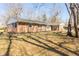 Expansive backyard featuring a well-maintained lawn, mature trees, and a classic brick home at 1621 Nottingham Dr, Indianapolis, IN 46240