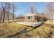 Wide view of a backyard with lawn, brick house, and wooden deck, perfect for outdoor enjoyment at 1621 Nottingham Dr, Indianapolis, IN 46240