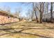 Generous backyard with a classic brick home, a deck, and a storage shed at 1621 Nottingham Dr, Indianapolis, IN 46240