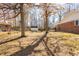 Backyard with large trees, grass, features a house and shed in the distance at 1621 Nottingham Dr, Indianapolis, IN 46240