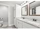 Bathroom featuring double sinks with granite counters, white cabinets, and a shower at 1621 Nottingham Dr, Indianapolis, IN 46240