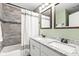 Updated bathroom showcasing a double sink vanity with granite countertop and a modern shower at 1621 Nottingham Dr, Indianapolis, IN 46240