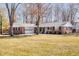 Charming single-story brick home with an attached garage and a well-maintained front lawn and mature trees at 1621 Nottingham Dr, Indianapolis, IN 46240
