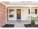 Inviting front porch featuring a decorative wreath on the front door, white columns and a cozy seating area at 1621 Nottingham Dr, Indianapolis, IN 46240
