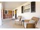 Cozy covered front porch with a seating area, complemented by white columns and a stylish front door at 1621 Nottingham Dr, Indianapolis, IN 46240