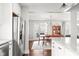Bright kitchen with granite countertops, stainless steel refrigerator, and view into the dining room at 1621 Nottingham Dr, Indianapolis, IN 46240