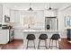 Bright kitchen with white cabinets, stainless steel appliances, granite countertops, and breakfast bar seating at 1621 Nottingham Dr, Indianapolis, IN 46240