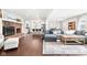 Spacious living room with a brick fireplace, hardwood floors, and a gray sectional sofa open to a modern kitchen at 1621 Nottingham Dr, Indianapolis, IN 46240