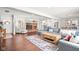 Open-concept living room with a brick fireplace, hardwood floors, and a comfortable gray sectional sofa at 1621 Nottingham Dr, Indianapolis, IN 46240
