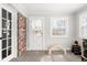 Sunlit room with door to the backyard and neutral carpet; ready to make your own at 1621 Nottingham Dr, Indianapolis, IN 46240