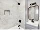 Bright bathroom features a shower and bathtub, with gray vanity and black fixtures at 1842 Tallman Ave, Indianapolis, IN 46218