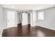 Bedroom with a dark wood floor, grey paint, and a closet with a sliding door at 1842 Tallman Ave, Indianapolis, IN 46218