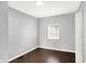 This bedroom features hardwood floors, light gray walls and natural light from the window with blinds at 1842 Tallman Ave, Indianapolis, IN 46218