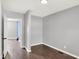 Bedroom with hardwood floors, light gray walls, and an open doorway leading to another room at 1842 Tallman Ave, Indianapolis, IN 46218