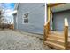 Home exterior has a wooden stairway to the back door and gravel landscaping at 1842 Tallman Ave, Indianapolis, IN 46218