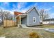 A charming house with blue siding, a red roof, a small front porch and a freshly landscaped yard at 1842 Tallman Ave, Indianapolis, IN 46218