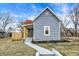Charming home featuring light blue siding, a welcoming front porch, and a well-maintained front yard at 1842 Tallman Ave, Indianapolis, IN 46218