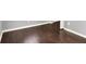 Close up on dark hardwood floors in a room with light gray walls and white trim at 1842 Tallman Ave, Indianapolis, IN 46218