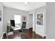 Well-lit home office with a desk, chair, bookshelf, and hardwood floors, perfect for remote work at 1842 Tallman Ave, Indianapolis, IN 46218