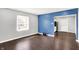 Inviting living room with hardwood floors, showcasing a large window and an open layout into the kitchen at 1842 Tallman Ave, Indianapolis, IN 46218