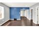 Bright living room featuring hardwood floors, gray and blue accent walls, offering an open and airy feel at 1842 Tallman Ave, Indianapolis, IN 46218