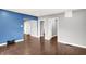 Spacious living room featuring hardwood floors and gray and blue accent walls with an open and airy feel at 1842 Tallman Ave, Indianapolis, IN 46218