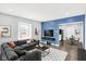 Stylized living room featuring an oversized gray couch, a sleek console, and an integrated dining area at 1842 Tallman Ave, Indianapolis, IN 46218