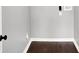 Empty room with dark wood floors and gray walls, base trim, and electrical outlets at 1842 Tallman Ave, Indianapolis, IN 46218