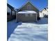 Backyard features a home exterior, a fence, and snow-covered ground at 2133 Webb St, Indianapolis, IN 46225
