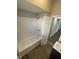 Bathroom featuring a tub/shower with white subway tile, modern fixtures, and wood-look floors at 2133 Webb St, Indianapolis, IN 46225