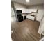 Modern kitchen featuring white cabinetry, black appliances and wood-look flooring at 2133 Webb St, Indianapolis, IN 46225