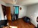 Bedroom with hardwood floors, small window, and a walk-in closet at 2503 S Lyons Ave, Indianapolis, IN 46241