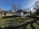 Side view of the home with a ramp, a green lawn, and a detached garage in the backyard at 2503 S Lyons Ave, Indianapolis, IN 46241