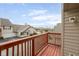 Balcony view of neighborhood houses and pond, with a red wooden railing in view at 3038 Wildcat Ln, Indianapolis, IN 46203